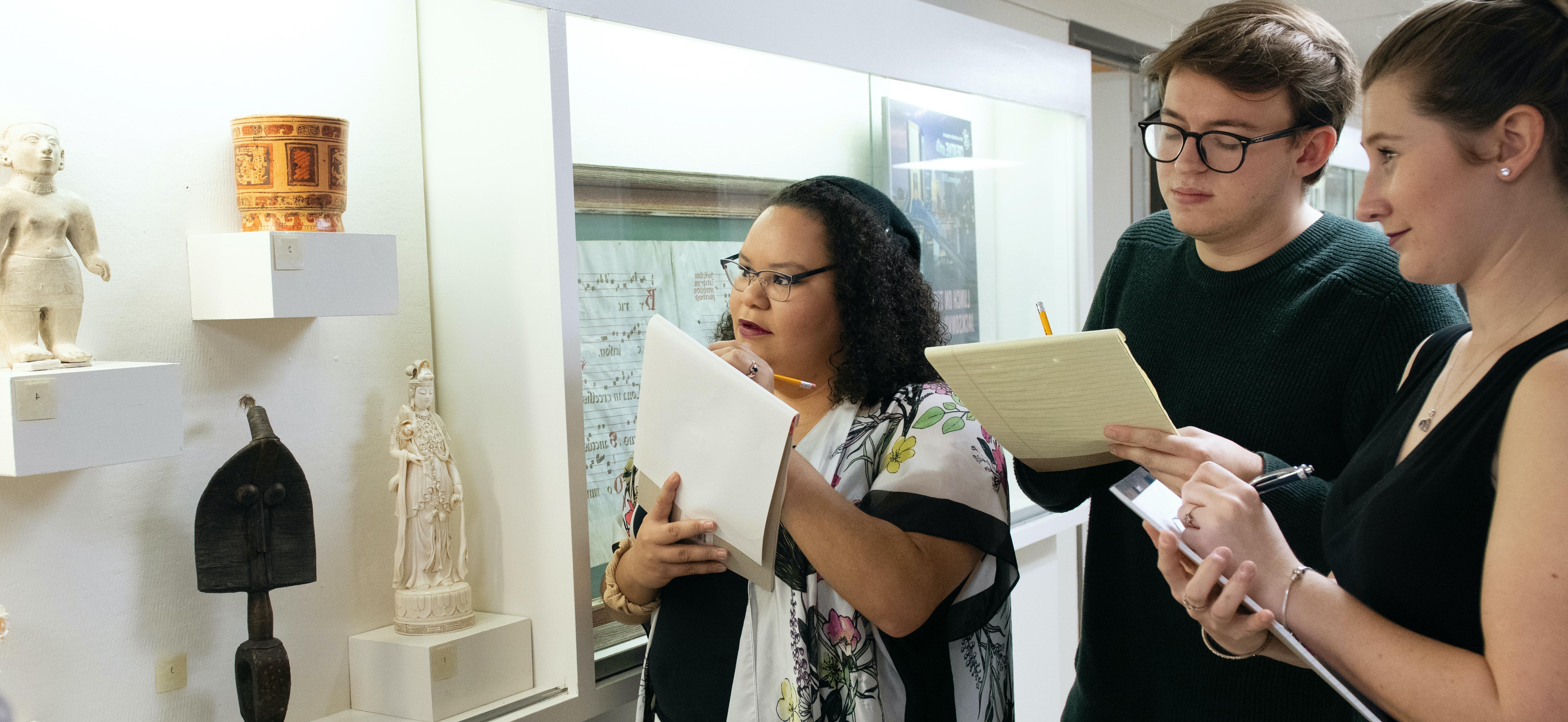 Art history students examining non-western objects from the University’s permanent collection.